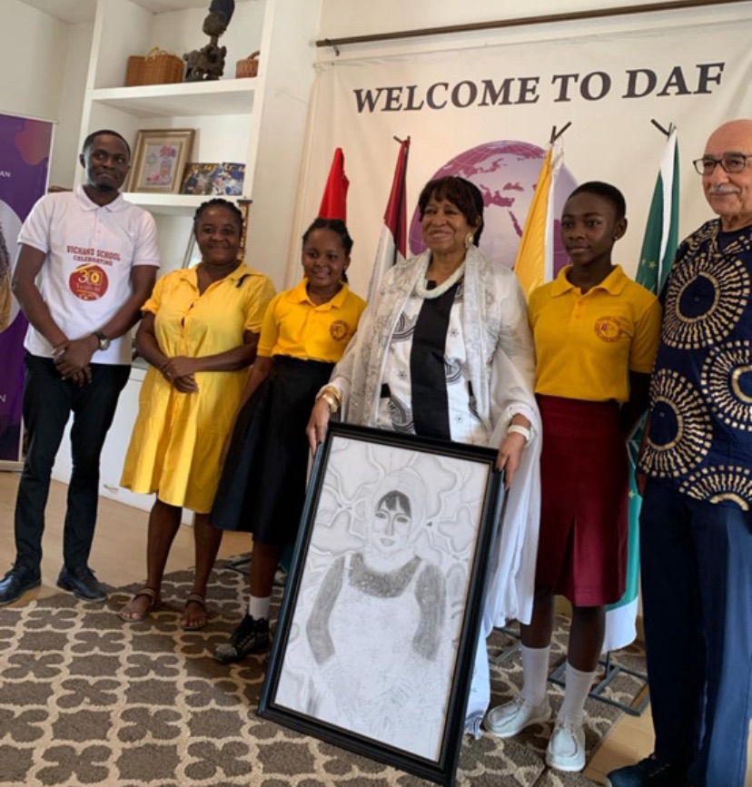 Kids in Tourism Team Presents Diaspora Africa Forum Ambassador, Dr. Erieka Bennett, with Penciled Portrait"